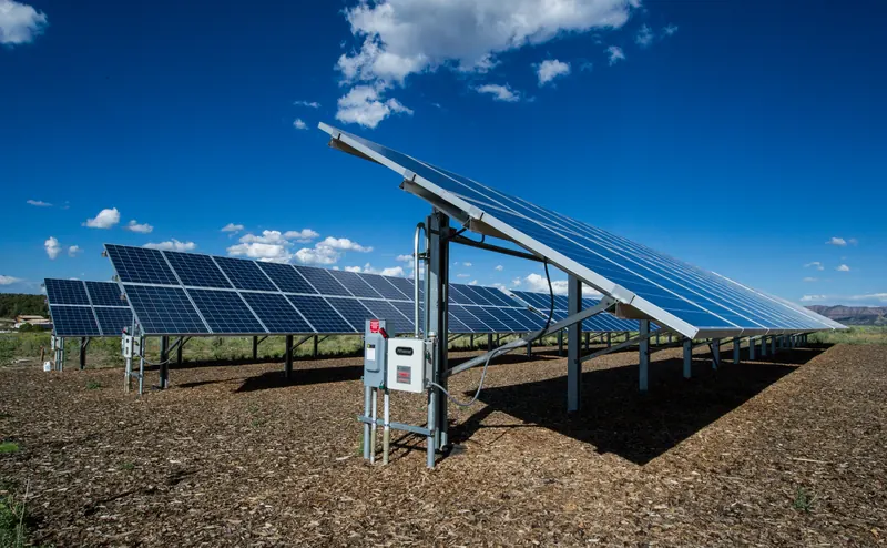 A photovoltaic array under a partly cloudy sky